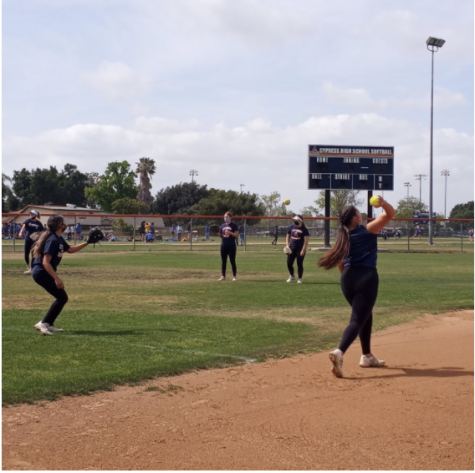 Softball team members warming up at practice on April 14, 2021.  Photo by Nevaeh Rangel