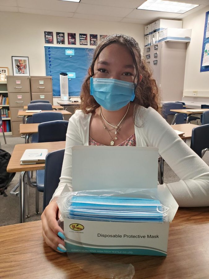 Freshman student Talania Wilson poses with masks indoors. Some students believe that requiring masks indoors is a good start, but doesnt go far enough.