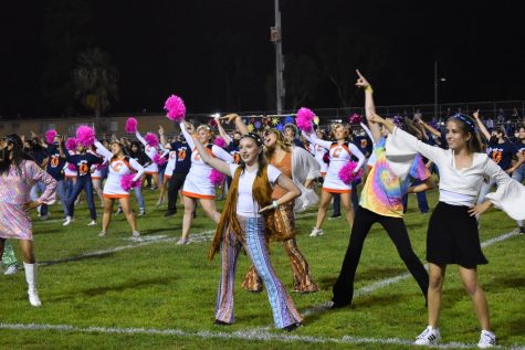 Dance, Cheer, Song and Choir give a high energy half-time performance during the game.