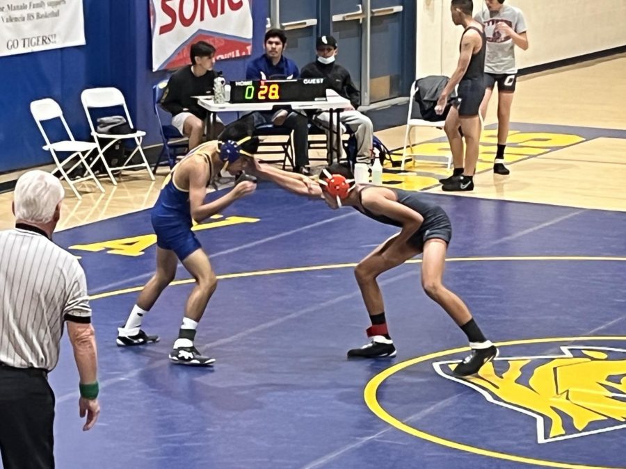 Freshman Enzo Olmedo goes against his opponent in individual league finals at Valencia High on February 4, 2022.
