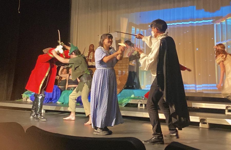 Peter Pan (Julian Aispuro) and Wendy (Emily Anesi) dramatically sword fighting Captain Hook (La Muir Metoyer) and his pirates onstage!
