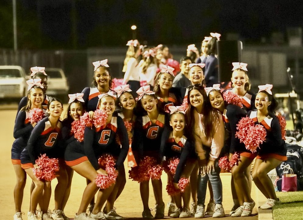 JV Cheer used pink pom poms during breast cancer awareness month.
