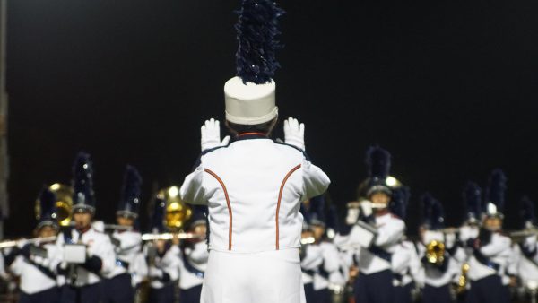 Drum Major Ryan Vo leading the band in the national anthem.