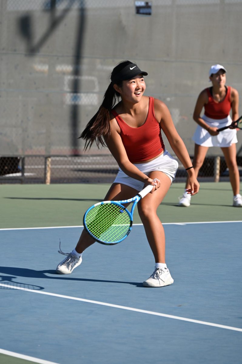 Junior Ashley Park swings for the ball showing off her skills on the court.