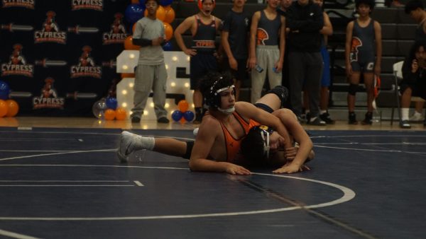 10th grader Branden Santos makes traps opponent under his arm.