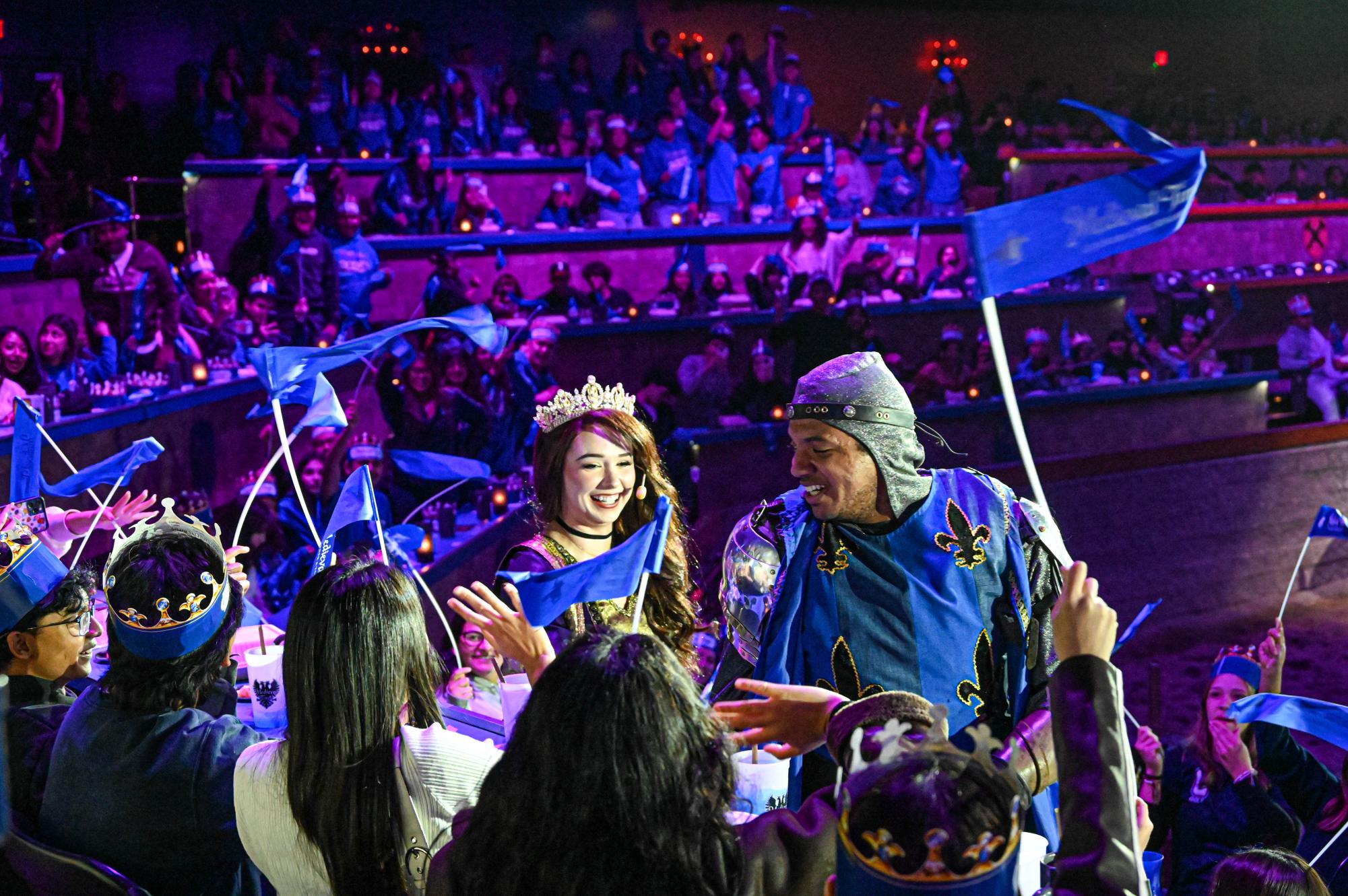  The queen and the knight that represented the blue "house" made their way after the show to crown two people in the audience. 