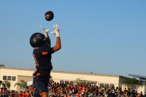 Varsity Running back Jaiden Anthony soars for the ball after a perfect pass from his teammate.