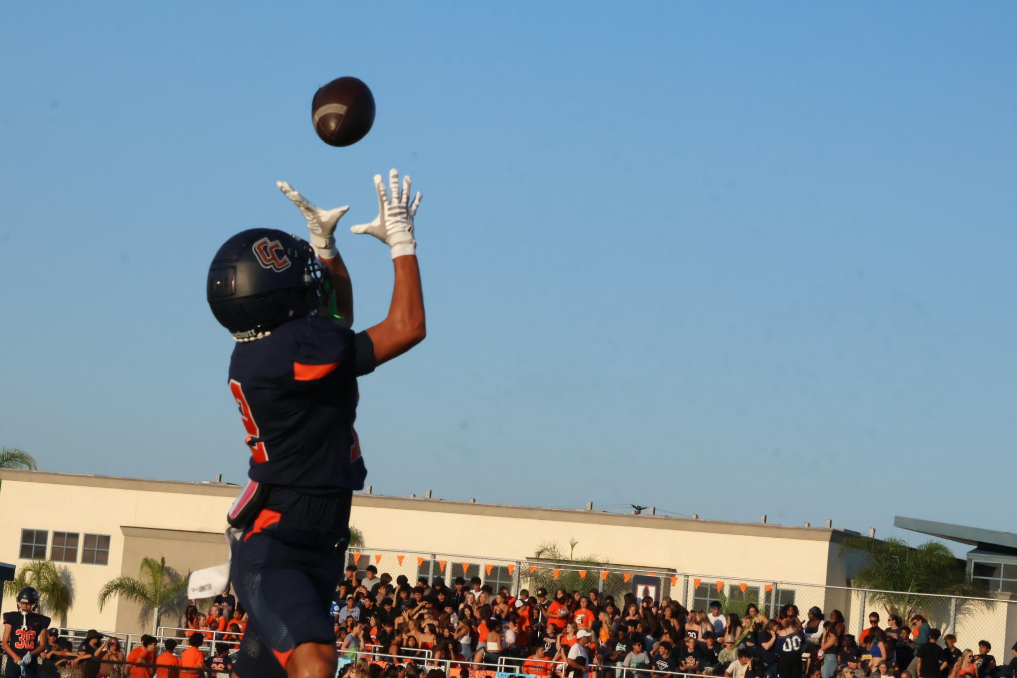 Varsity Running back Jaiden Anthony soars for the ball after a perfect pass from his teammate.