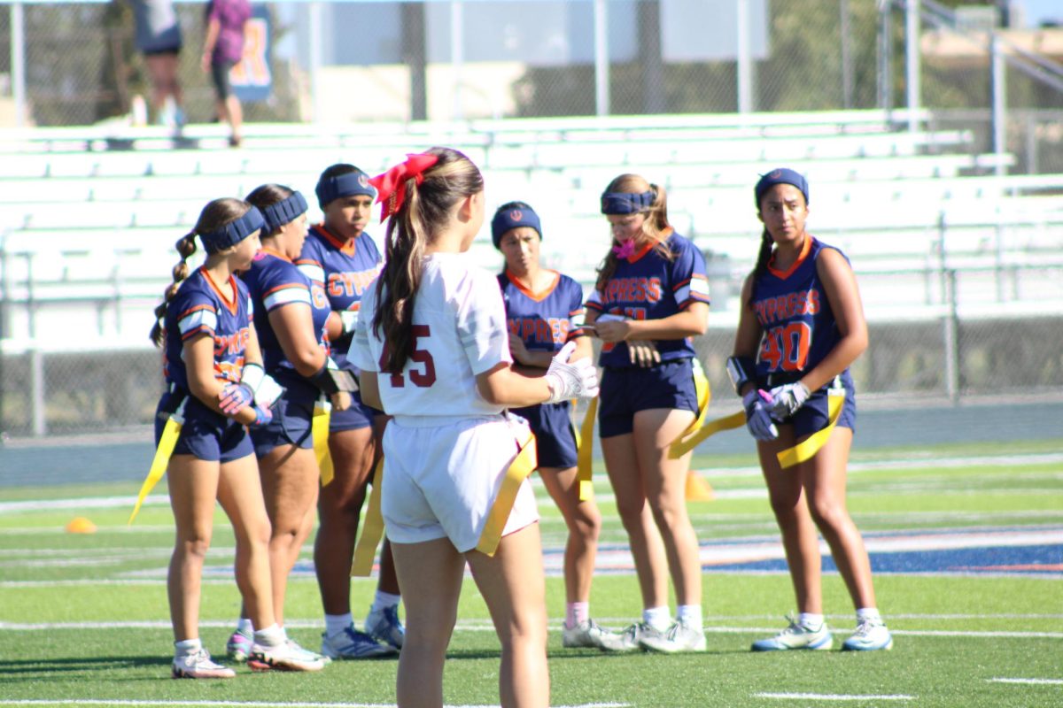 Girls Freshman Flag Football deciding how to win against Esperanza as a team, during the first 15 of the game. 