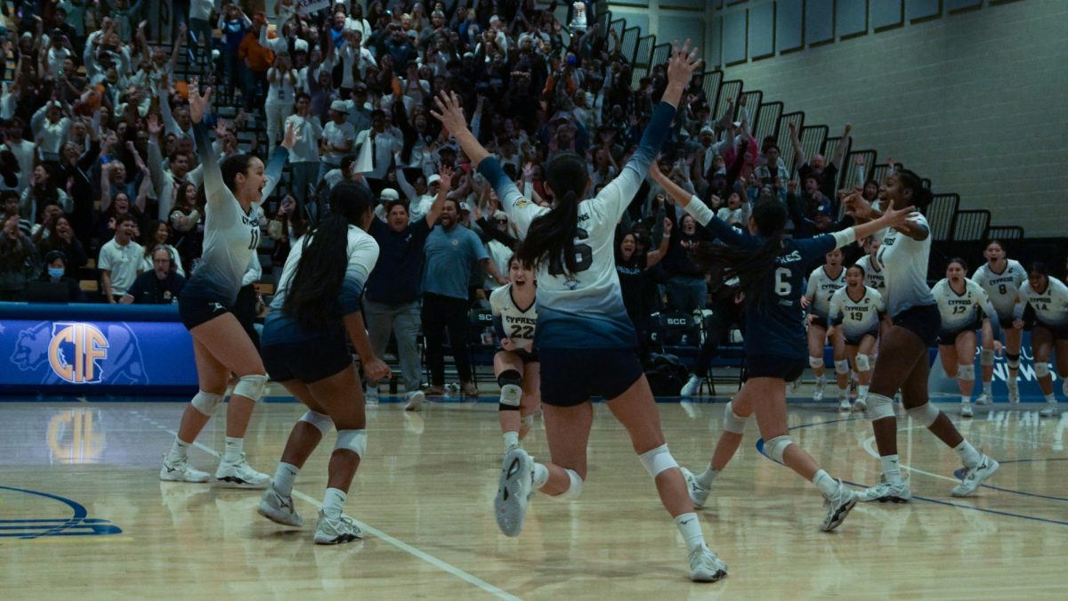 The team celebrates the moment that the ball hits the opponents court on the gamewinning point, earning them a CIF state championship title.