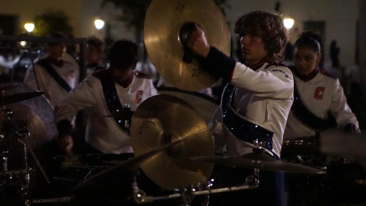 Marimba player Adrian Vasquez crashes cymbals to finish off the show.